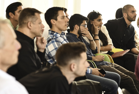A group of people sitting down looking away