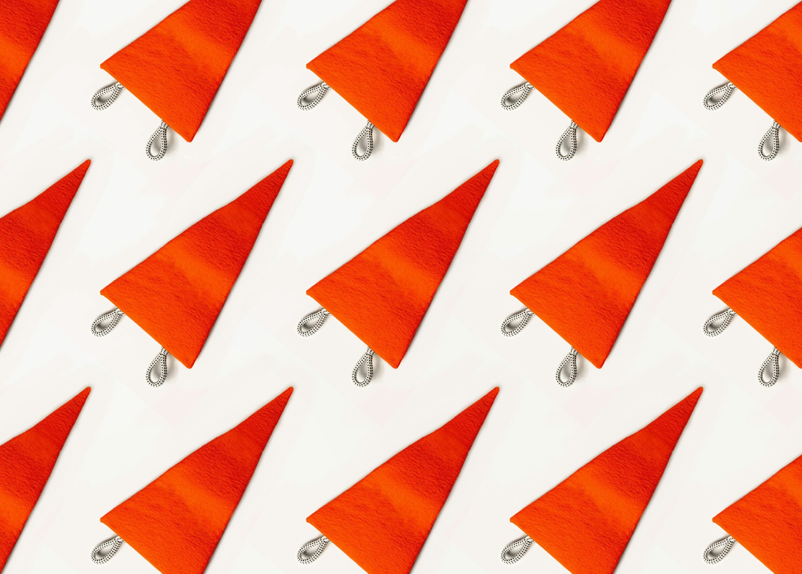 Red coloured flags laying flat on a cream backdrop